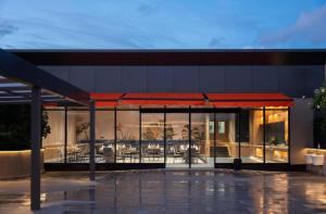 a building with a restaurant with tables and chairs at The Canvas Loft-Manyata Tech Park-Orchid Parc in Bangalore