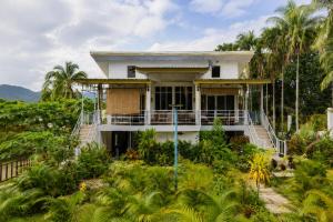a house on a hill with palm trees at Kopan House View Point by WildFlower in Thong Sala