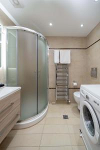 a bathroom with a shower and a washing machine at Argostοli Bay Apartments in Argostoli +91 photos