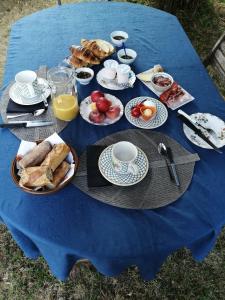 a table with a blue table cloth with breakfast food on it at Pause Périgord in Saint-Cyprien