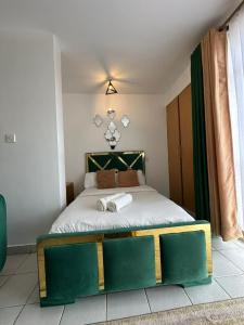 a bedroom with a large bed in a room at Ngong Road Luxe Studio in Nairobi
