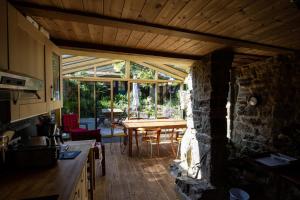 a kitchen with a wooden ceiling and a table at Le Magasin à Sel in Crozon
