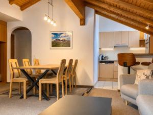 a kitchen and a living room with a table and chairs at Chasa Sot-Chaunt 301 in Samnaun