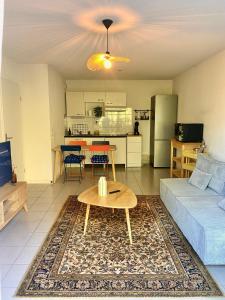 a living room with a couch and a table at Labenne beach apartment in Labenne