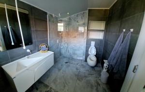 a bathroom with a white sink and a toilet at ОмниЯ Терас in Chernomorets