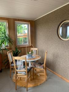 a dining room with a table and chairs and a mirror at Villa Mariett in Kuressaare