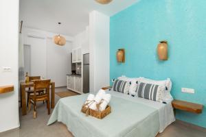a blue bedroom with a bed and a table at Villa Balliu Panorama in Tripiti