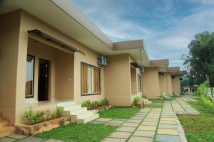 a row of houses with stairs in front of them at Bekal Eden Resorts in Kāsaragod +4 photos