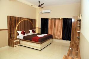 a bedroom with a large bed in a room at Bekal Eden Resorts in Kāsaragod