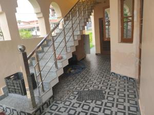 a staircase in a house with a tiled floor at Bali cottage in Jammu