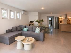 a living room with a couch and a table at Aegean Horizon Seafront Luxury Villa Plomari Garden Level in Trýgonas