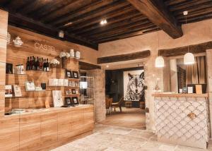 a room with a store with a dog on the wall at Castel de Très Girard - Hotel & Restaurant - Teritoria in Morey-Saint-Denis