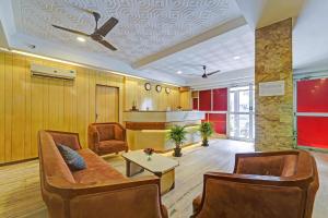 a living room with a couch and chairs and a table at RG SUITES Mount Road in Chennai