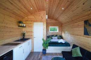 a room with a bed in a log cabin at The Nest @The Outside Inn in Mountfield