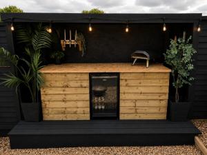 a barbershop with a black wall and lights at The Nest @The Outside Inn in Mountfield
