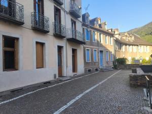 an empty street in a town with buildings at Furnished T2 apartment in Luchon