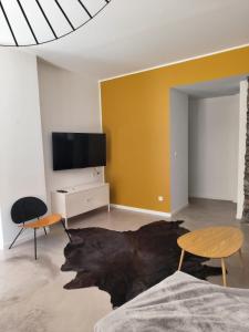 a living room with a tv and two chairs at Furnished T2 apartment in Luchon
