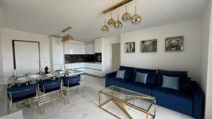 a living room with a blue couch and a table at Laguna Blu in Montepaone Lido