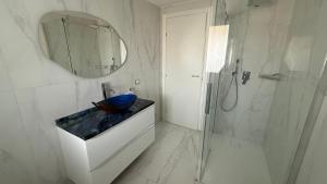a bathroom with a sink and a shower and a mirror at Laguna Blu in Montepaone Lido +29 photos