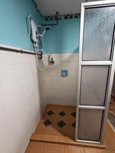 a shower with a glass door in a bathroom at Shakim hotel in Cukai +9 photos