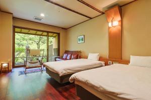 a hotel room with two beds and a balcony at Yumenoian Yuyake Koyake in Himeji +95 photos