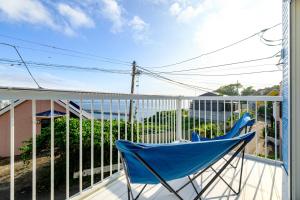 a blue rocking chair sitting on a balcony at Hale Kai Akiya in Yokosuka