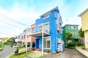 a blue building in a row of houses at Hale Kai Akiya in Yokosuka