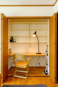a room with a chair and a desk and a lamp at Hale Kai Akiya in Yokosuka +69 photos
