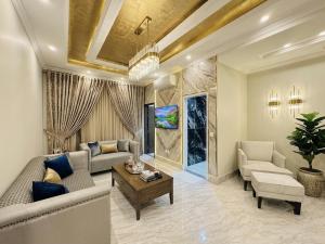 a living room with a couch and a table at Regency Suite Hotel in Lahore