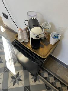 a coffee maker sitting on a table in a kitchen at Villa Rosazza in San Salvatore Monferrato