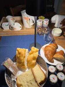 a table topped with a plate of bread and pastries at Villa Rosazza in San Salvatore Monferrato +7 photos