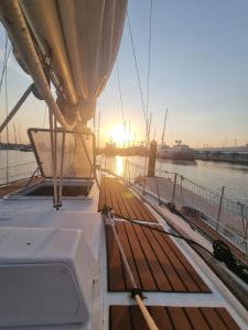 a boat in the water with the sun setting at Velero en Puerto Valencia Mar -E&M Boats in Valencia +5 photos