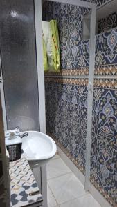 a bathroom with a sink and a shower at Belle apt près de la mer in Tangier