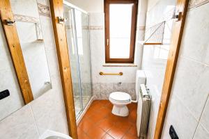 a bathroom with a toilet and a shower at Shila House in Luino