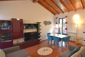 a living room with a couch and a table and chairs at Shila House in Luino +7 photos