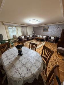a living room with a table and chairs and a couch at Большой дом в Степанаване in Stepʼanavan