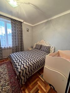 a small bedroom with a bed and a window at Большой дом в Степанаване in Stepʼanavan