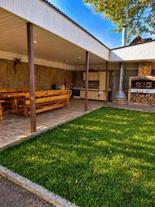 a patio with a picnic bench and a grill at Большой дом в Степанаване in Stepʼanavan