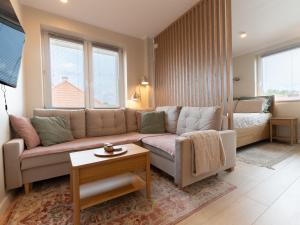 a living room with a couch and a table at Apartament Bohaterów in Giżycko