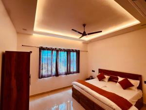 a bedroom with a bed and a ceiling fan at ramraz residency in Ayodhya