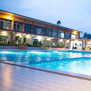 a large swimming pool in front of a building at Chris Hotel in Runda