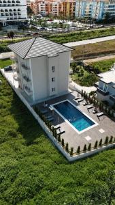 an overhead view of a building with a swimming pool at Arkej Pool Aparthotel in Golem