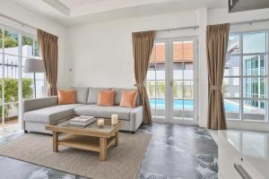 a living room with a couch and a table at Luxury Pool Villa Pattaya Center C3- 3 Bedroom in Pattaya South