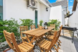a wooden table and chairs on a patio with a piano at Luxury Pool Villa Pattaya Center C3- 3 Bedroom in Pattaya South