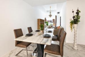 a dining room with a white table and chairs at Luxury Pool Villa Pattaya Center C3- 3 Bedroom in Pattaya South