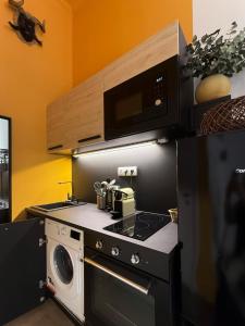 a kitchen with a stove and a microwave at BBB Parkside Studio city center in Budapest