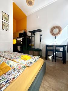 a bedroom with a bed and a desk and a table at BBB Parkside Studio city center in Budapest +18 photos