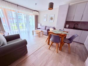 a living room with a couch and a table at Azymut in Darłowo