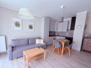 a living room with a couch and a table at Azymut in Darłowo +11 photos