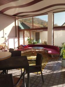 a patio with a couch and tables and chairs at İsmayıllı bağ evi in İkinci Yeniyol